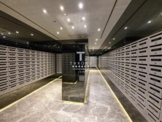 Mailroom with numerous mailboxes and modern lighting