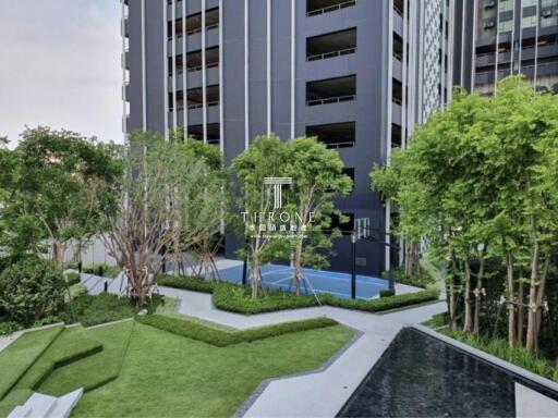 Modern residential building with landscaped garden and playground area