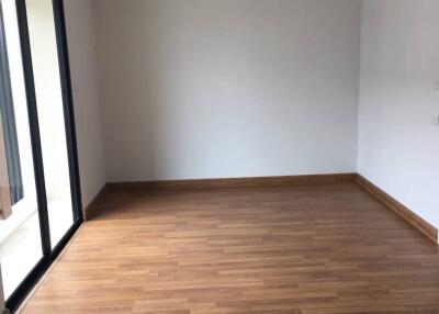 Unfurnished living room space with wooden floor and large window