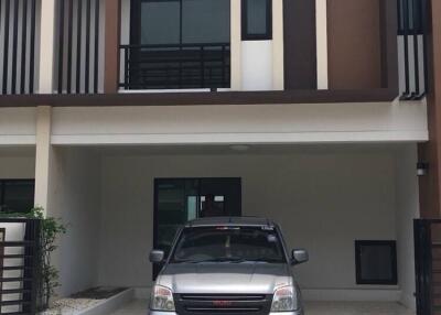 Front view of a building with a parked car