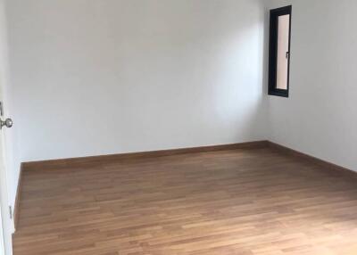 empty bedroom with wooden floor and a window