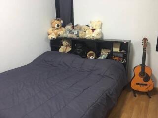 Bedroom with bed, shelf, and stuffed animals