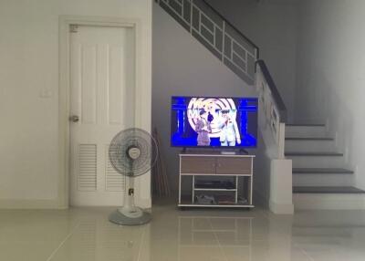 Living room with TV and staircase