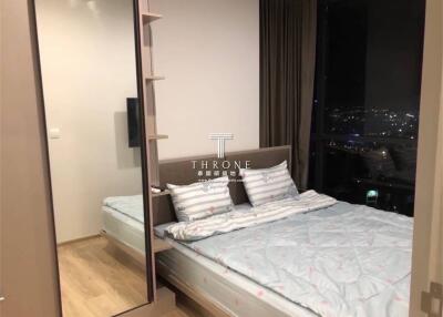 Cozy bedroom with large bed and city view
