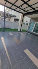 Spacious outdoor patio area with seating and tiled flooring