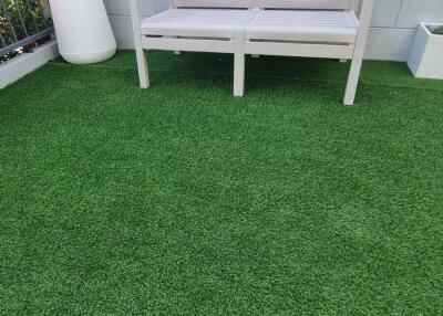 Outdoor area with bench on artificial grass