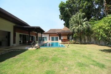 Outdoor view of a house with a swimming pool and garden