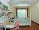 A cozy bedroom with a bed, study desk, and bookshelves