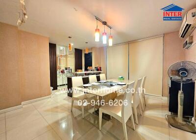 Modern dining area with table, chairs, air conditioning, and decorative lighting