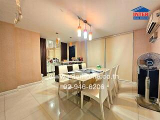 Modern dining area with table, chairs, air conditioning, and decorative lighting