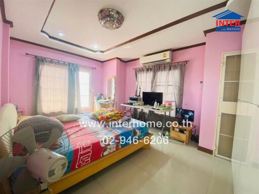 Spacious bedroom with pink walls, a double bed, and multiple windows.