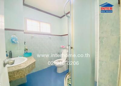 Bright bathroom with a shower, toilet, and sink