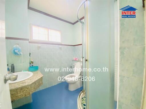 Bright bathroom with a shower, toilet, and sink