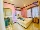 Bright bedroom with bed, air conditioner, standing fan, and luggage