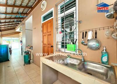 Kitchen with sink, storage, and cooking utensils