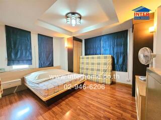 Bedroom with wooden flooring and modern ceiling light