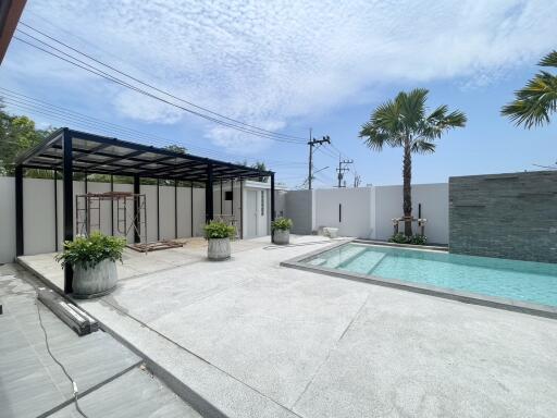 Modern patio with swimming pool and seating area