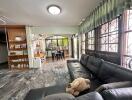 Spacious living area with large windows and adjacent dining room