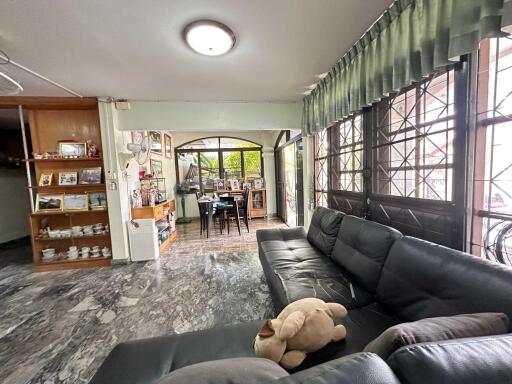 Spacious living area with large windows and adjacent dining room