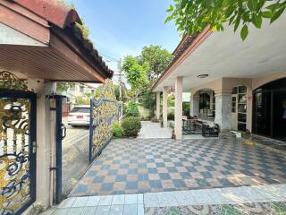 Outdoor area with tiled flooring, gate and carport