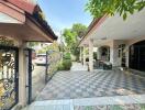 Outdoor area with tiled flooring, gate and carport