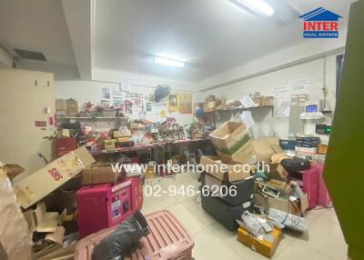 Cluttered storage room filled with boxes and miscellaneous items