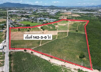 Aerial view of a large plot of land with boundaries marked in red