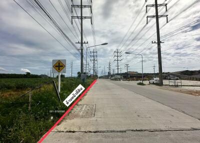 Paved road with power lines and signage
