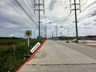 Paved road with power lines and signage