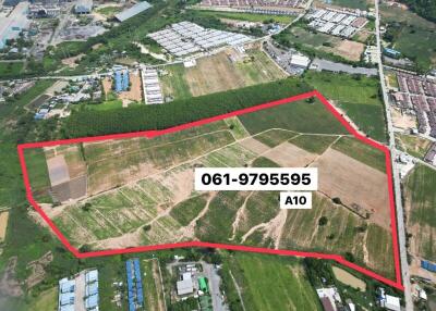 Aerial view of a large plot of land outlined in red with contact number displayed