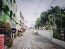 Street view of neighborhood with shops and greenery