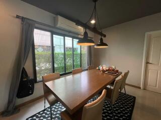 Dining room with large wooden table and hanging lamps