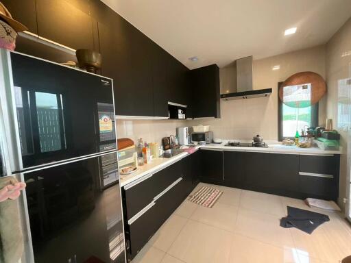 Modern kitchen with black cabinets and white countertops