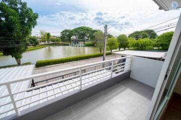 Balcony with a view of a pond and greenery