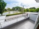 Balcony with a view of a pond and greenery