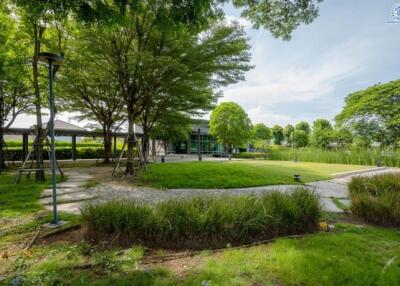 Exterior view of a modern building surrounded by greenery and pathways