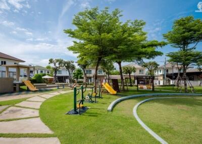 Community playground and park area with greenery