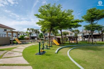 Community playground and park area with greenery