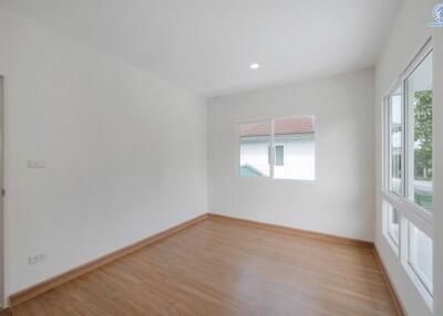 empty bedroom with wooden floor and white walls