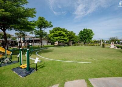 Well-maintained communal green space with outdoor gym equipment