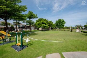 Well-maintained communal green space with outdoor gym equipment