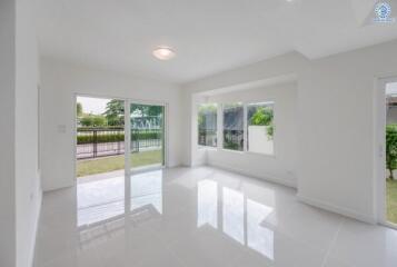 Spacious living room with large windows and sliding glass door