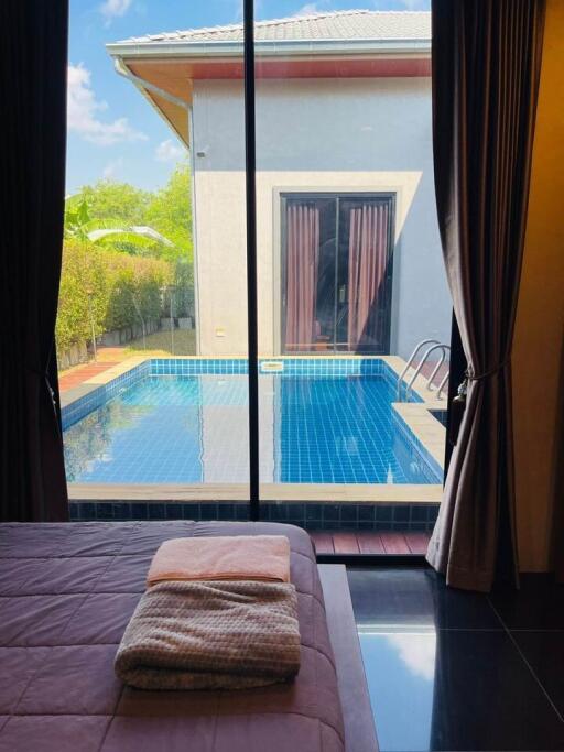 Bedroom with view of private swimming pool