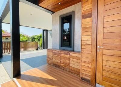 Main entrance with wooden door and accent walls