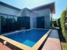 Outdoor swimming pool with wooden deck