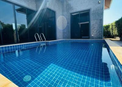Modern house with a blue-tiled swimming pool