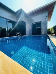 Modern house with a blue-tiled swimming pool