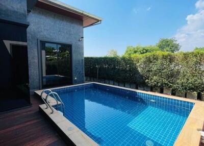 Outdoor swimming pool with a wooden deck