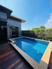 Outdoor swimming pool with a wooden deck