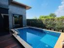 Outdoor swimming pool with a wooden deck